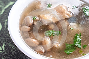 Taiwan`s distinctive famous snacks: Peanut pork knucklepig`s trotter soup in a white bowl on stone table, Taiwan Delicacies