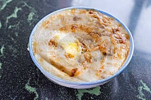 Taiwan`s distinctive famous snacks: Savory rice pudding Wa gui in a white bowl on stone table, Taiwan Delicacies