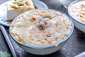 Taiwan`s distinctive famous snacks: Savory rice pudding Wa gui in a white bowl on stone table, Taiwan Delicacies