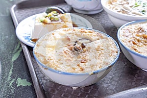 Taiwan`s distinctive famous snacks: Savory rice pudding Wa gui in a white bowl on stone table, Taiwan Delicacies