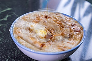 Taiwan`s distinctive famous snacks: Savory rice pudding Wa gui in a white bowl on stone table, Taiwan Delicacies