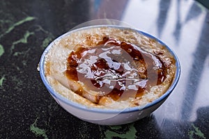 Taiwan`s distinctive famous snacks: Savory rice pudding Wa gui in a white bowl on stone table, Taiwan Delicacies
