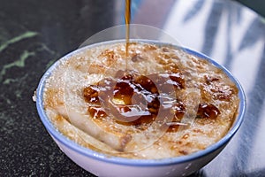 Taiwan`s distinctive famous snacks: Savory rice pudding Wa gui in a white bowl on stone table, Taiwan Delicacies