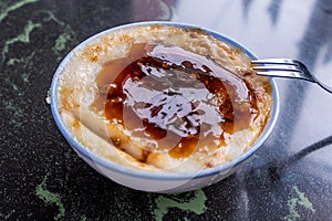 Taiwan`s distinctive famous snacks: Savory rice pudding Wa gui in a white bowl on stone table, Taiwan Delicacies, Taiwan Street