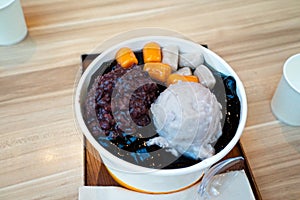 Taiwanese flavor dessert, Shaved Ice topping with taro ball, sweet potato ball, grass jelly and scoop of taro ice cream photo