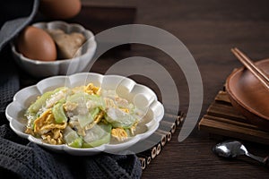 Taiwanese homemade local food of scrambled eggs with loofah gourd and sesame oil