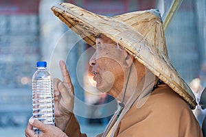 Taiwanese monk at the Wenwu temple blessing a bottle of water