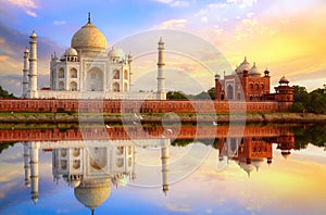 Taj Mahal Agra at sunset with water reflection and moody sky