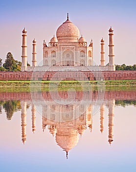 Taj Mahal famous marble mausoleum at sunset, on the south bank of the Yamuna river in the Indian city of Agra, India