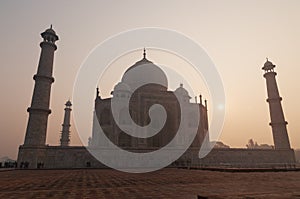 Taj Mahal in the fog at sunrise