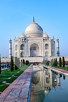 Taj Mahal in India with reflection in pond and with the inscription of the coran in arabic letter meaning in english: This is an