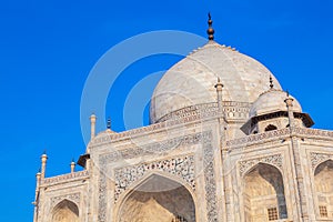 Taj Mahal in India under blue sky with the inscription of the coran in arabic letter meaning in english: This is an invitation to photo