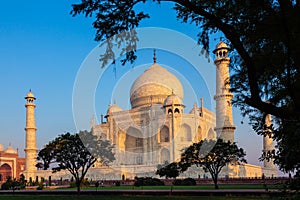 Taj Mahal in morning light with the inscription of the coran in arabic letter meaning in english: This is an invitation to live on photo