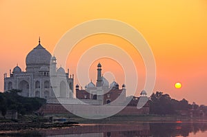 Taj Mahal reflected in Yamuna river at sunset in Agra, India