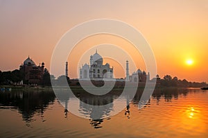 Taj Mahal reflected in Yamuna river at sunset in Agra, India