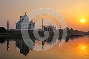 Taj Mahal reflected in Yamuna river at sunset in Agra, India