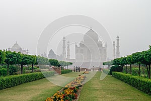 Taj Mahal view in morning fog from across the Mehtab Bagh or The