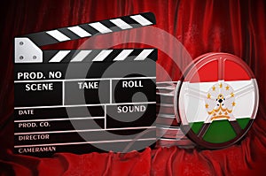 Tajik cinematography, film industry, cinema in Tajikistan. Clapperboard with and film reels on the red fabric, 3D rendering