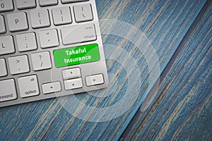 TAKAFUL INSURANCE text on button of computer keyboard.