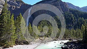 Takakkaw Falls Waterfall and Yoho River in a sunny summer day. Yoho National Park, Canadian Rockies