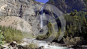 Takakkaw Falls Waterfall and Yoho River in a sunny summer day. Yoho National Park, Canadian Rockies