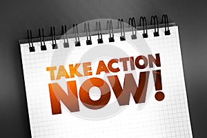 Take Action Now text quote on notepad, concept background