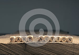 Take action on small wooden blocks photo