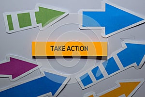 Take Action text on sticky notes isolated on office desk
