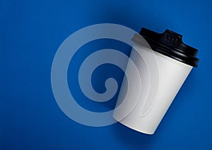 Take away coffee cup on blue background