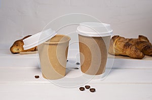 Take Away Coffee and Fresh Croissant With Chocolate drops on wooden background, Copy Space