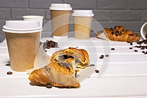 Take Away Coffee with Fresh Croissant With Chocolate and Coffee Beans on wooden background, Copy Space