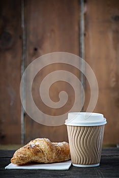 Take away coffee and fresh croissant