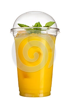 Take-away drink. Refreshing drink in a plastic cup. Pineapple juice with ice cubes and mint.