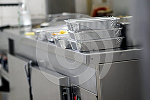 Take away food in foil boxes in Chinese restaurant kitchen