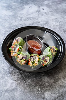 Take Away Healthy Asian Vietnamese Spring Roll / Goicuon with Rice Paper Rolls and Red Hot Chili Sauce in Plastic Container Plate