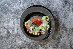 Take Away Healthy Asian Vietnamese Spring Roll / Goicuon with Rice Paper Rolls and Red Hot Chili Sauce in Plastic Container Plate