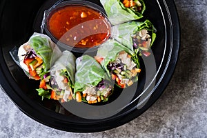 Take Away Healthy Asian Vietnamese Spring Roll / Goicuon with Rice Paper Rolls and Red Hot Chili Sauce in Plastic Container Plate