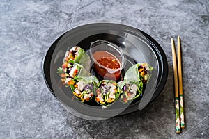 Take Away Healthy Asian Vietnamese Spring Roll / Goicuon with Rice Paper Rolls and Red Hot Chili Sauce in Plastic Container Plate
