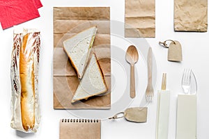 Take away with sandwich and paper bags on table background top view