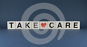 Take Care. The cubes form the word Take Care