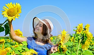 Take care of it. pretty kid with flower. beauty of summer nature. little girl in sunflower field. yellow flower of