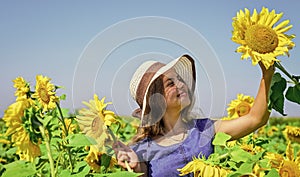 Take care of it. pretty kid with flower. beauty of summer nature. little girl in sunflower field. yellow flower of