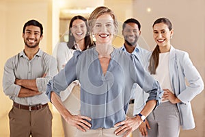 Take charge of your success. Portrait of a mature businesswoman standing in an office with her colleagues in the