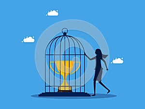 Take control of the victory. woman imprisoned the trophy in the birdcage. business concept