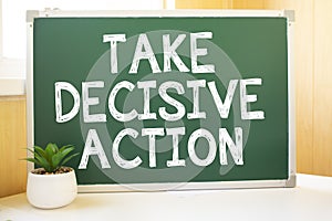TAKE DECISIVE ACTION in chalk on the school board, Search engine optimization and websites. Desk, swept balls of paper, computer