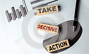 TAKE DECISIVE ACTION wooden block on chart background