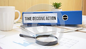 TAKE DECISIVE ACTION words on labels with document binders