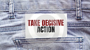 TAKE DECISIVE ACTION words on a white paper stuck out from jeans pocket. Business concept