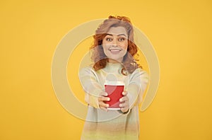 take this. happy red haired woman drink coffee. take away beverage. cheerful girl drinking tea