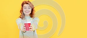 take this. happy red haired woman drink coffee. take away beverage. cheerful girl drinking tea. Woman isolated face